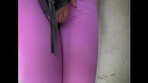 Blonde woman urinates her latex stretch pants outside